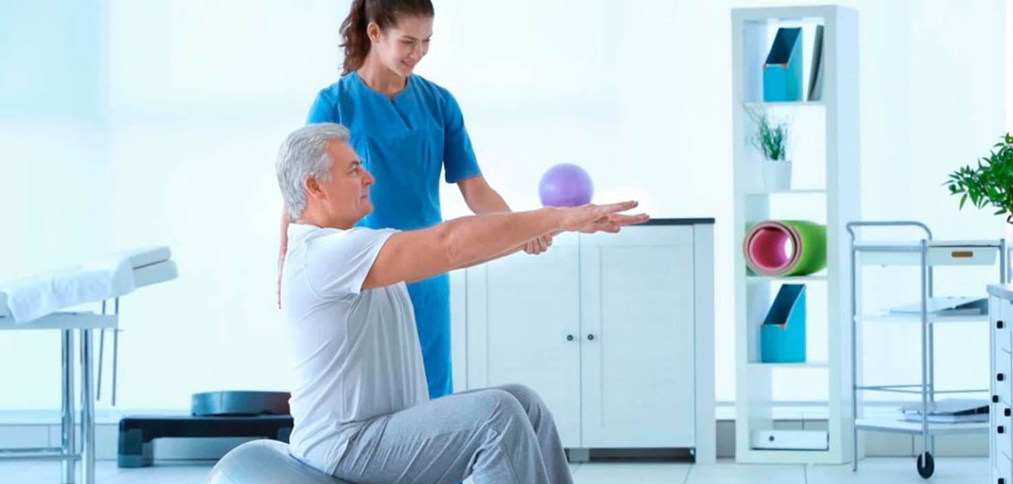 A physiotherapist guiding a patient through a recovery exercise at Activa Clinics